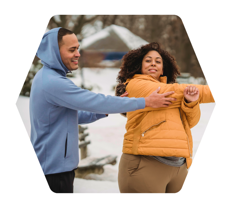 Man and woman stretch before exercising outside